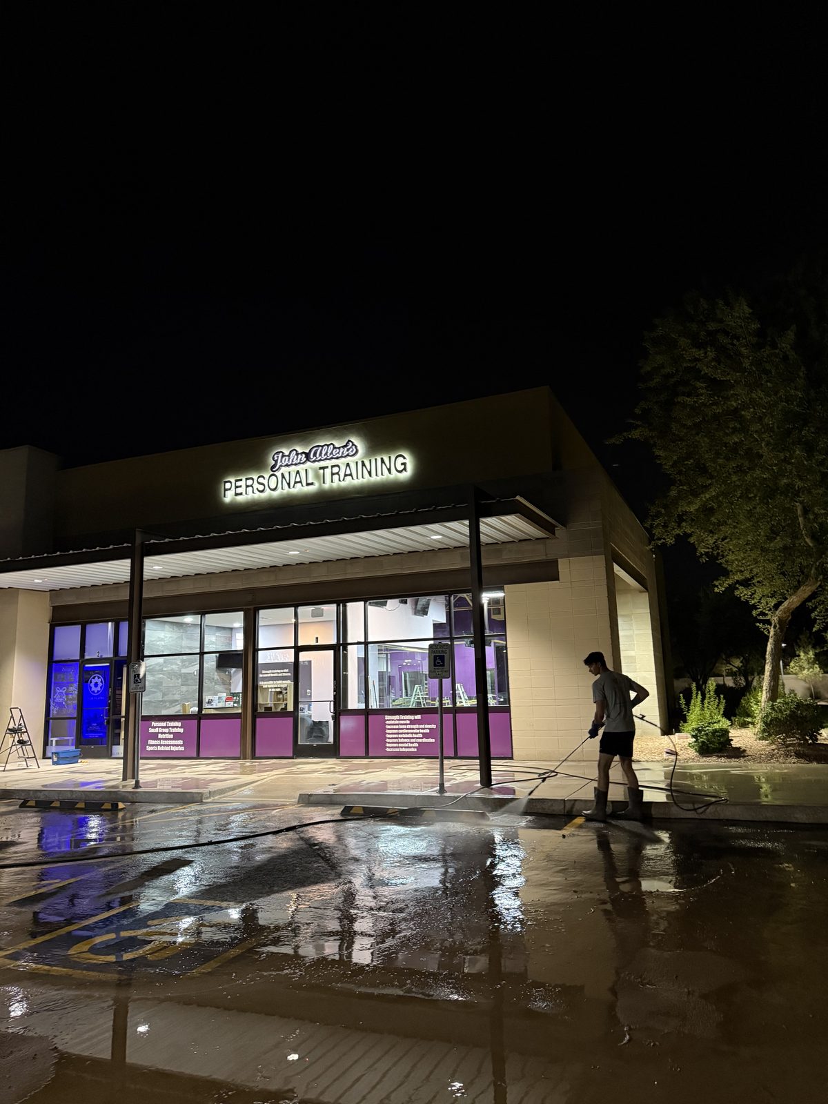 Freshly pressure-washed sidewalk and storefront after Velo Property Solutions service